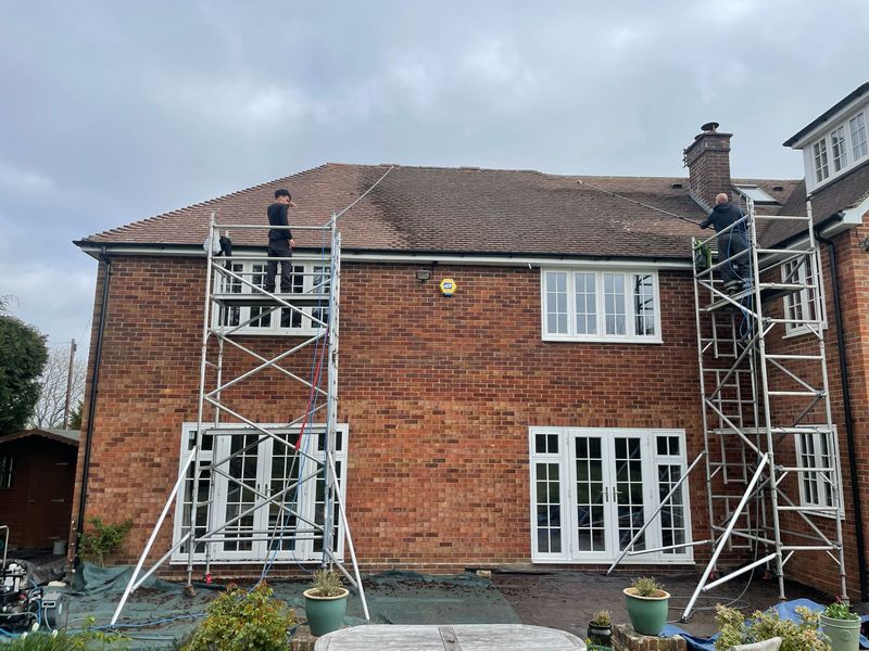 Roof cleaning carried out safely from scaffold towers by The Roof Moss Cleaners in Hatfield
